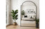 Large Adair arch mirror in modern living room reflecting sofa, wall art, plants and décor.