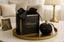 Black scented candle with decorative packaging on a table