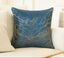 Decorative pillow with blue and gold pattern on a beige sofa