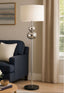 Floor lamp with decorative base in a living room setting