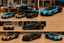 A collage showing multiple toy sports cars modeled after a Bugatti Chiron, displayed in different color combinations on a wooden tabletop with a bedroom background visible in several panels.