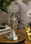 Decorative candle holder with crystal embellishments on a table in a home setting