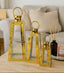 Set of gold pyramid lanterns on a table with a blurred background