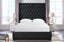 Ella Winged Bed in black velvet styled in a modern bedroom interior.