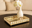 Decorative mirror gold tray with a vase and flowers on a table