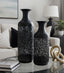 Black decorative vases on a table in a living room setting