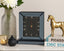 Decorative Mirrored Smoke Grey clock on a shelf with a vase, candle, and gold horse statue.