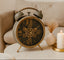 Decorative Antique Grey Gear Table clock with gears on a surface next to a candle