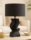 Black table lamp on a coffee table with a blurred background