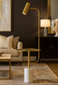 Modern living room with a gold floor lamp and side table.