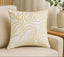 Decorative pillow with gold patterns on a beige couch