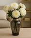Decorative vase with white flowers on a table in a room setting