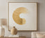 Decorative wall art with a gold circular design in a living room setting.