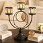 Decorative candle holder with three candle holders on a table.