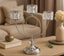 Decorative silver candelabra with crystal accents on a table.