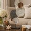 Abstract table decor on a coffee table with flower vase and candles in a living room setting