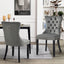 Alsea dark grey velvet dining chairs styled in modern dining room with table setting.