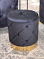 Black Amy Storage Ottoman with gold base styled in room setting with modern décor