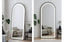Black LED arch mirror leaning in stylish living space adding depth light and modern elegance