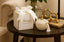 Decorative candle and box on a table with a blurred background