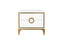 White Balmain bedside table with gold trim showcasing two drawers and signature circular gold handle.