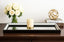 Decorative Beaded Black Tray on a console table with flowers, candle, and sculpture.