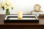 Decorative Mirrored Medium Black Tray a vase of white roses, candle, and decorative sphere on a table.