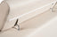 Close-up of Brighton cream leather lounge showing adjustable headrest mechanism with chrome support brackets and smooth upholstery.