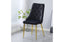 Black velvet button tufted dining chair with gold legs styled in a modern dining space.