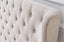 Close-up of Cambridge Bed tufted headboard in soft tan beige linen fabric.