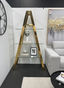 Gold glass Capella shelf styled in living room displaying books décor and modern decorative accents
