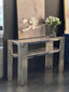 Chelsea console table with polished silver frame and white marble top styled with décor.