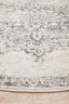 Close-up of round silver rug showing soft textured weave and detailed grey patterns.