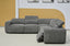 Cleo boucle modular lounge in grey fabric with recliner extended, styled in modern room.