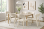 Cream dining chairs styled around table in modern dining room setting