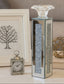 Decorative table candle holder with crystal base and clock on a neutral background