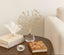 crystal tree decor setting with books and a decorative piece on a table.