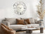 Silver mirrored Roman numeral clock styled in modern living room, chic wall décor accent.