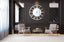 Extra-large silver mirrored Roman numeral clock styled in luxury sitting area, elegant statement.