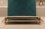 Go;d mirror tray on a table with a blurred background