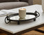Decorative black metal mirrored tray with a candle on a coffee table
