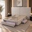 A modern upholstered bed frame with a tall segmented headboard and built-in storage drawers, shown in a styled bedroom setting with warm lighting and wood flooring.