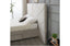 Side angle of velvet bed showing extended headboard and upholstered base.