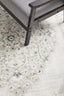 Close-up of Emotion 77 Green Rug showing elegant woven texture and subtle green floral detailing on cream base