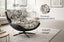 Black and white fabric Enzo swivel chair in living room setting highlighting 360 degree swivel and premium texture.