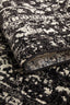 Folded edge of Evoke Charcoal Rug highlighting dense weave