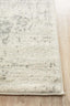 Thick serge edge of white silver rug on wooden floor