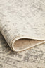 Folded corner of white silver rug showcasing weave and texture