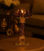 Decorative candle holder with a lit candle on a blurred background