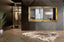 Gold French provincial deluxe mirror styled horizontally in modern dark interior with rug and décor.
